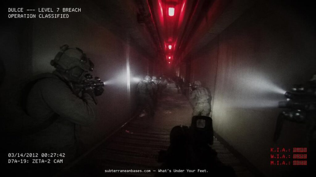 Military personnel in tactical gear pressed against walls of a steep underground corridor under red emergency lighting with weapon-mounted flashlights cutting through smoke